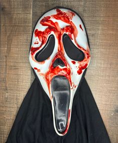 This Listing Includes a Custom Scream (2022) Hero Style Reshrouded 25th Anniversary Ghostface Mask with a Bloodied Handprint Effect Across the Face of the Mask. The Mask Itself Has Been Fitted with an Ultrawhite Mouth Piece and has Been Reshrouded with an Enlarged Shroud with Attached Velcro. Eye Mesh Has Also Been Replaced. Scream Face, Ghostface Mask, Custom Mask, The Mask, Hand Print, 25th Anniversary, Scream, The Face, Gift Card