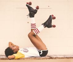 a woman laying on top of a bench with her feet up and skateboards in the air