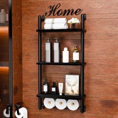 a bathroom wall shelf with toilet paper and personal care items on it, along with the word home