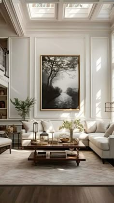 a living room filled with furniture and a large painting on the wall above it's windows