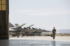 an air force jet sitting on top of an airport tarmac next to another plane