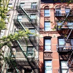 an apartment building with several balconies and fire escapes