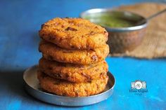 a stack of fried food sitting on top of a metal plate next to a bowl