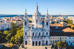 an aerial view of a church in the middle of a city with lots of trees