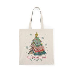 a tote bag with an all booked for christmas tree design on the front