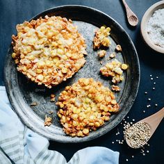 two pieces of food sitting on top of a pan next to a spoon and bowl