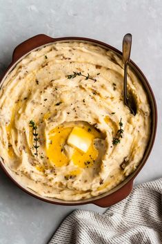 a bowl filled with mashed potatoes topped with an egg