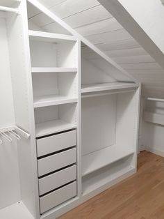 an empty white closet with shelves and drawers