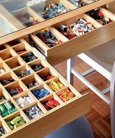 a wooden desk with drawers filled with legos