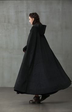 "Few things will make you want to leave your house on a chilly day, but this cloak coat will provide the encouragement you need. Since \"Linennaive Cloak\" being a hot keyword on social media these years, the team have upgraded till now 11 versions to create awe-inspiring quality wool cloaks. Crafted with a maxi length and a thick wool construction this tailored outwerwear ensures you'll remain perfectly comfortable on even the chilliest of days. Featuring the Grade A cashmere, deep side pockets Dark Cloak, Wool Coat Outfit, Cloak Black, Black Cloak, Cloak Coat, Hooded Wool Coat, Cashmere Cape, Black Cape, Black Winter Coat