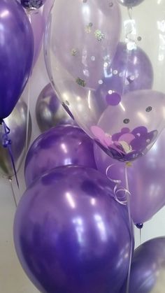 purple and silver balloons are floating in the air