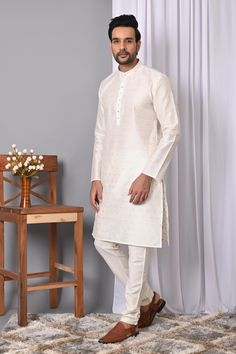 Description: Elevate your ethnic wardrobe with Richart's Men's  White Jacquard Silk Kurta Pyjama, the epitome of quality and affordability. Since 2015, Richart has been committed to maintaining superior standards in every piece, ensuring you always look your best. Exquisite Design and Fabric: This standout kurta features a stylish self-design crafted from luxurious Jacquard silk, paired with a silk blend churidar pyjama. The vibrant green kurta and classic white pyjama make an eye-catching combination perfect for any special occasion. Perfect for Special Occasions: Ideal for weddings, festivals, and parties, this ensemble can be effortlessly paired with embroidered mojris to complete your traditional look. Product Details: Style: Zari Jacquard Silk Kurta with Off-White Silk Blend Churidar Luxury Classic White Kurta, Luxury White Jamawar Kurta, White Kurta Set, Occassion Dress, Mens Ethnic Wear, Wedding Kurta, Kurta Men, Kurta Pyjama, White Pajamas