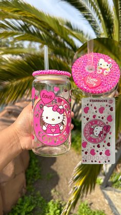 hello kitty tumbler cup with lid and straw in the palm tree next to it