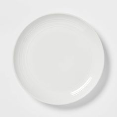 an empty white plate on a white surface