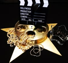 a movie clapper and some jewelry on a star