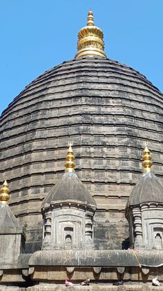 the top of an old building with gold domes