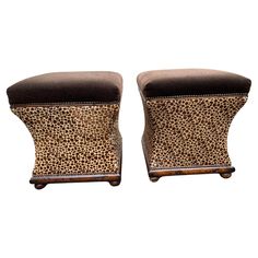 a pair of stools with leopard print upholstered on them