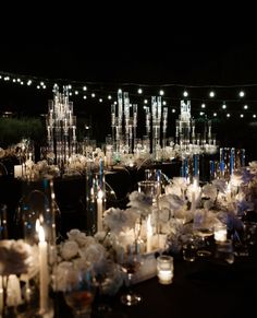 the tables are set up with candles and flower centerpieces for an elegant reception