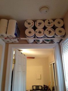 several rolls of toilet paper are stacked on top of each other above the door way