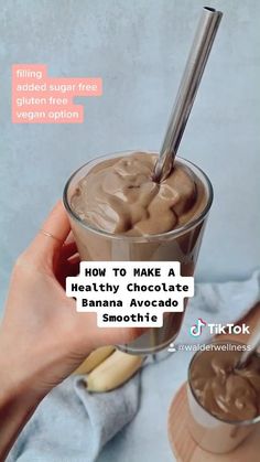 a person holding a glass with chocolate pudding in it and text overlay that reads how to make a healthy chocolate banana avocado smoothie smoothie