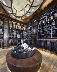 the inside of a men's clothing store with wooden floors and shelves filled with jeans