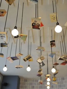 several different pictures of the inside of a restaurant with tables, chairs and books hanging from the ceiling