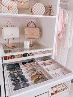 a white closet filled with lots of purses and handbags