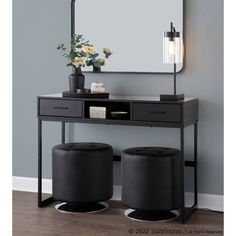 a vanity with two stools and a large mirror on the wall above it in a room