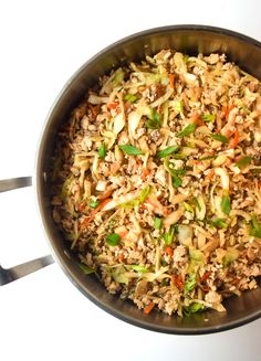 a pan filled with rice and vegetables on top of a table