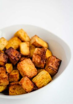 a white bowl filled with fried tofu