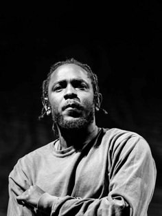 a black and white photo of a man with his arms crossed