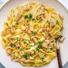 a white plate topped with pasta and chicken