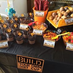 a table topped with lots of cupcakes and candy