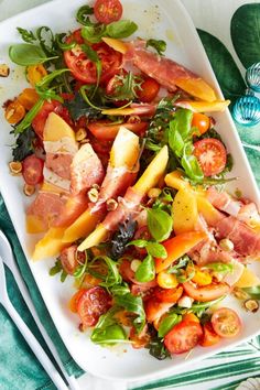 a white plate topped with salad and meat