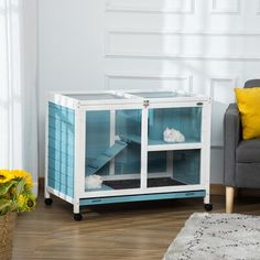 a living room with a gray couch and a blue cabinet