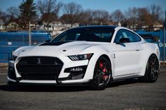 the front end of a white sports car