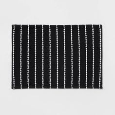 a black and white striped rug on a white background