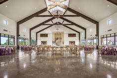 a large room with tables, chairs and chandeliers on the ceiling is set up for a formal function