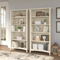 two white bookcases sitting next to each other in a living room