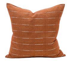 a brown pillow with white lines on it