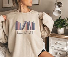 "\"I Have No Shelf Control\" Adorable and funny sweater made for book lovers! Sweatshirt features original artwork by Amanda Hamm (me) of a cute, colorful bookshelf. This super comfy sweatshirt is made with a soft cotton/polyester blend that helps the clothing keep its shape after multiple washes.   DETAILS: Materials - 50%cotton, 50% polyester Medium-heavy fabric (8.0 oz/yd² (271.25 g/m Available Colors - White, Black, Sand, Grey, Light Pink, Light Blue, Maroon, Navy, Dark Heather, and Forest Green Loose fit Sewn-in label Runs true to size CARE INSTRUCTIONS: Non-chlorine: bleach as needed; Do not iron; Do not dry-clean; Machine wash: cold (max 30C or 90F); Tumble dry: low heat." Colorful Bookshelf, No Shelf Control, Book Reader Gifts, Reader Gifts, Funny Sweater, Lover Sweatshirt, Funny Sweaters, Comfy Sweatshirt, Grey Light