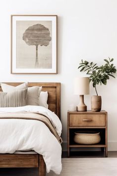 a bedroom with a bed, nightstand and plant on the side table in front of it