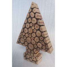 a wooden christmas tree made out of logs