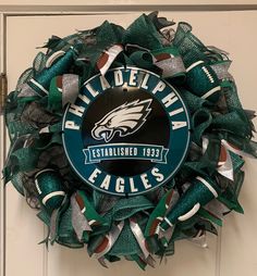 the philadelphia eagles wreath is hanging on the door