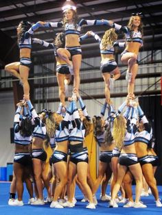 a group of cheerleaders standing on top of each other