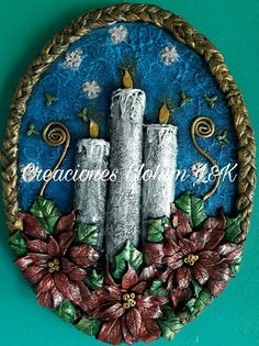 decorative wall hanging with three candles and poinsettis on blue background, surrounded by flowers