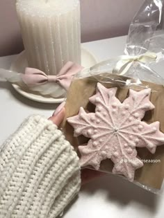 a person is holding some cookies in their hand next to a cup and saucer