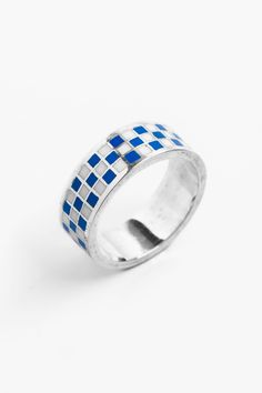 Introducing the "Gambit Ring" by Merchants of the Sun: a captivating and unisex handmade jewelry piece. Crafted from 925 sterling silver, this minimalist band ring features a striking blue checkered pattern in enamel. Elevate your style with the "Gambit Ring" and make a bold statement with its unique design. If time is spent, the Gambit is calculated. Each moment within its mesmerising grid is a carefully measured manoeuvre. The trust found in formulaic rhythms and patterns is boldly embodied by The Gambit, Pattern Ring, Blue Checkered, Silver Enamel, Recycled Sterling Silver, Checkered Pattern, Engraved Rings, Unique Rings, Band Ring