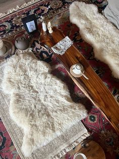 a living room area with rugs, coffee table and other items on the floor