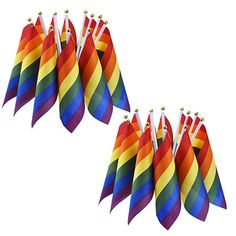 several rainbow colored kites are lined up in a row on a white background with gold beads